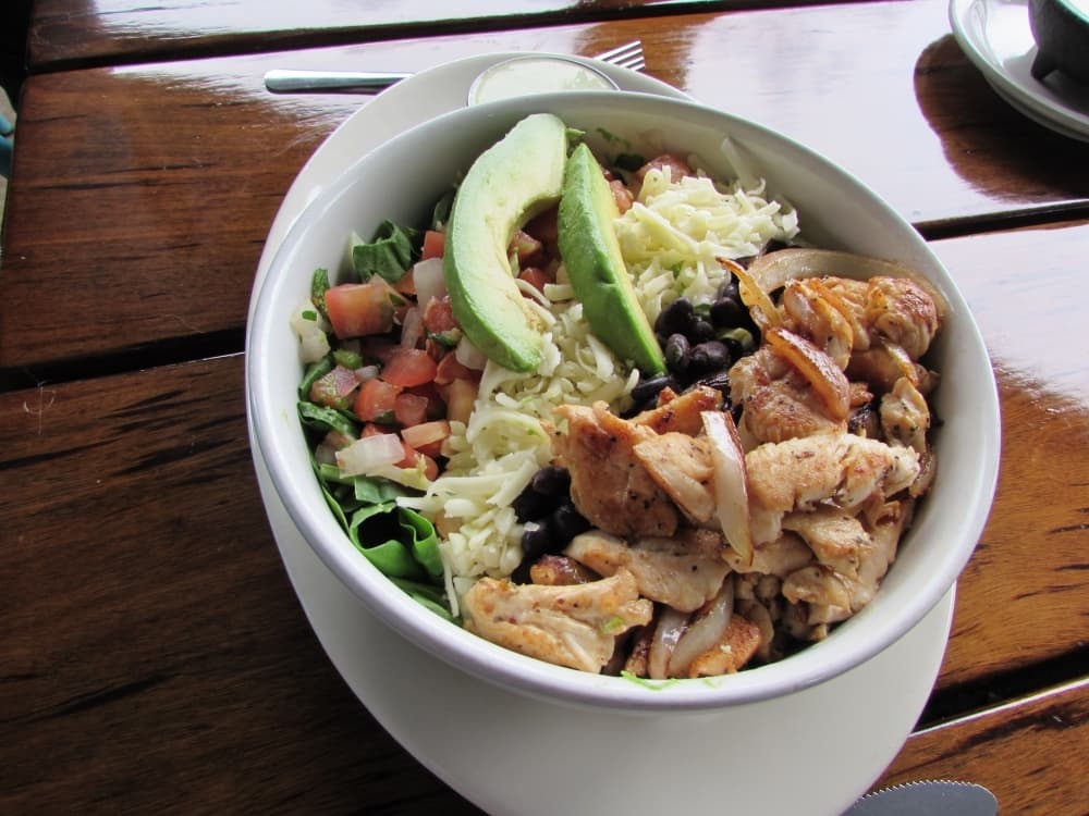 The Powerbowl is a layered salad with rice, beans, cheese, pico de gallo, chicken and avocado. (Nicholas Cicale/Community Impact Newspaper)