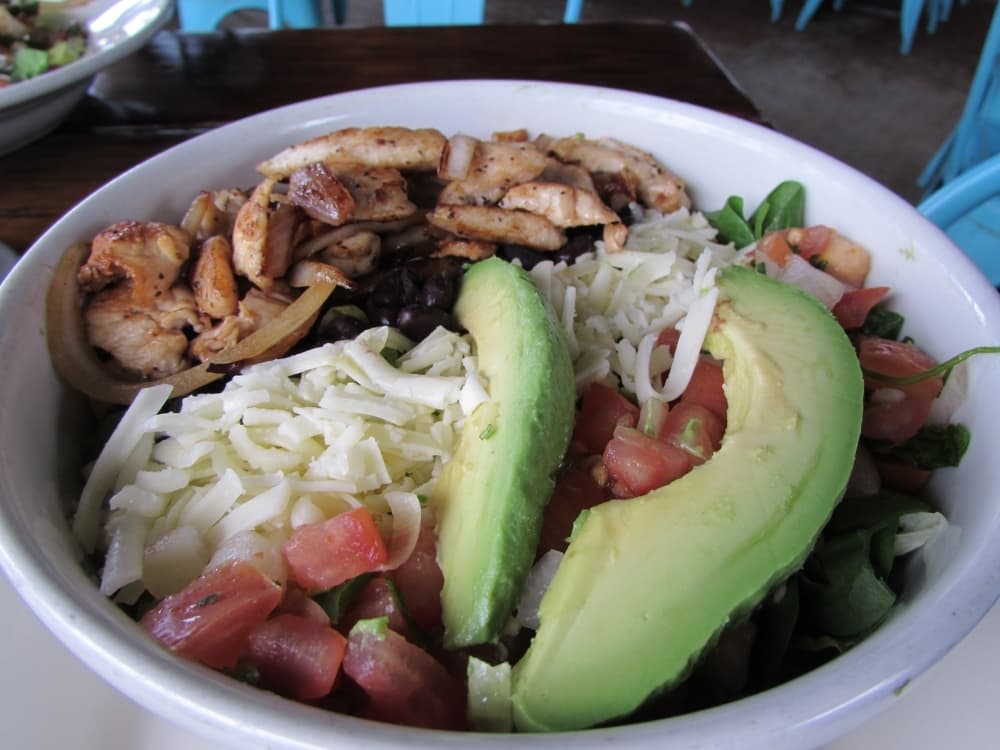 The Powerbowl is a layered salad with rice, beans, cheese, pico de gallo, chicken and avocado. (Nicholas Cicale/Community Impact Newspaper)