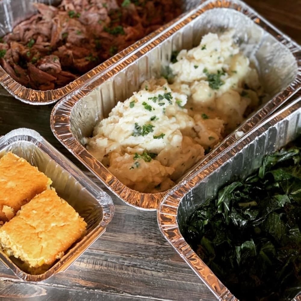 Pulled pork, mashed potatoes and gravy and collard greens are available in half-portion sizes and come with cornbread ($45). (Courtesy Mason and Dixie)