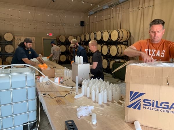 Desert Door's staff fills bottles of hand sanitizer to distribute to local residents. (Courtesy Desert Door Texas Sotol)