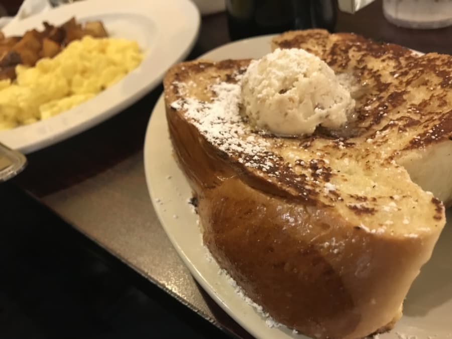 Fork & Spoon's French Toast is a customer favorite and is served on challah bread with powdered sugar and honey pecan butter. (Community Impact Newspaper)
