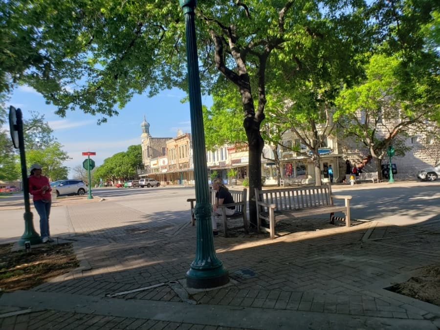 Those who were out made sure to maintain six-feet of distance while talking on the Georgetown Square April 1.  (Ali Linan/Community Impact Newspaper)