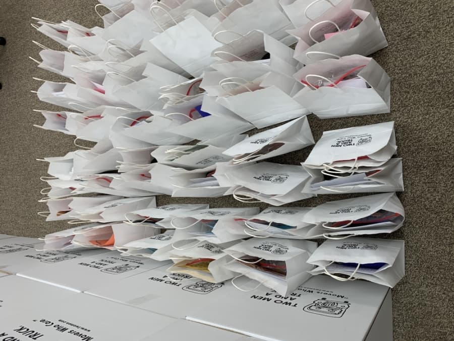 The bags contained face masks, protein bars, snacks, lip balms, children’s toys and coloring books as well as handmade cards. (Courtesy Two Men and A Truck)