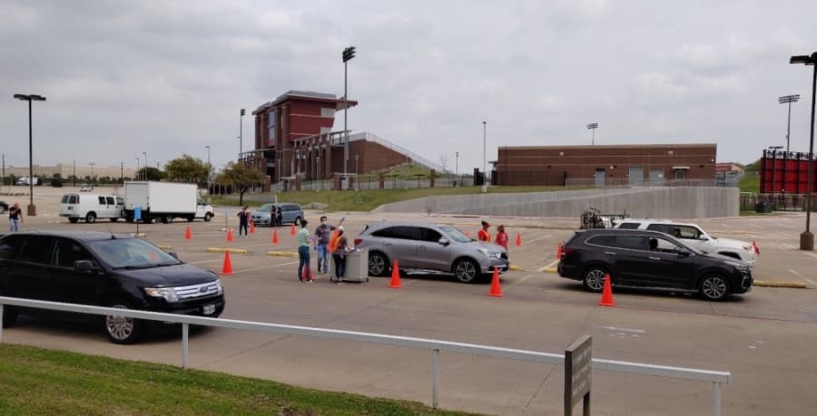 GCISD technology support staff organize cars in a drive-thru to provide technology repairs. (Courtesy Grapevine-Colleyville ISD)