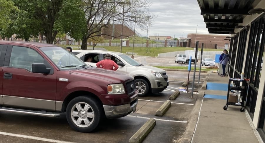 GCISD technology support staff organize cars in a drive-thru to provide technology repairs. (Courtesy Grapevine-Colleyville ISD)