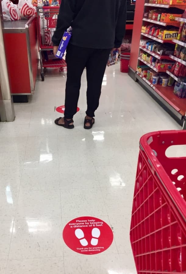 Target employees have placed markers 6 feet apart at the checkout line to reinforce social distancing. (Taylor Jackson Buchanan/Community Impact Newspaper)