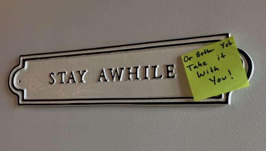 Atop a decorative sign inside the coffee shop, Summer Moon staff added a handwritten note reminding customers to take their beverages to go. (Taylor Jackson Buchanan/Community Impact Newspaper)