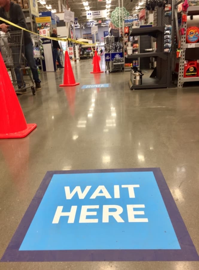 Lowes staff have placed markers 6 feet apart at the checkout line to reinforce social distancing. (Taylor Jackson Buchanan/Community Impact Newspaper)