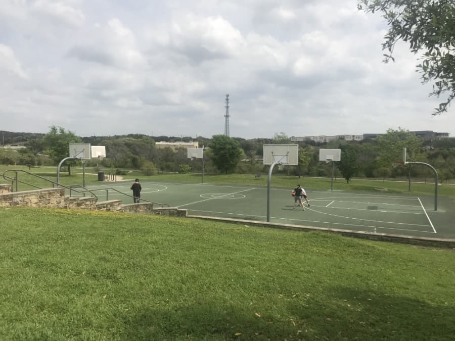 Three residents utilize Bee Cave's Central Park basketball court on March 27 at 12:51 p.m. (Amy Rae Dadamo/Community Impact Newspaper)