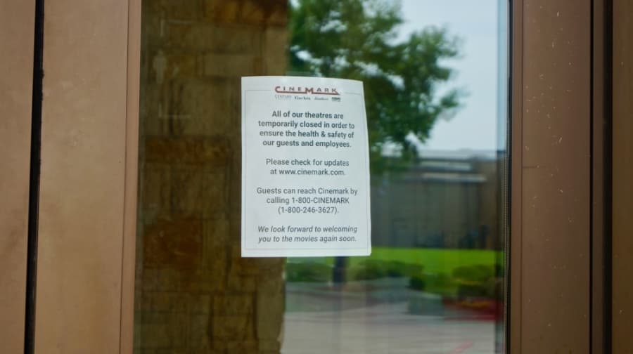 A sign posted to the front door of Cinemark, turning away patrons. (Kelsey Thompson/Community Impact Newspaper)
