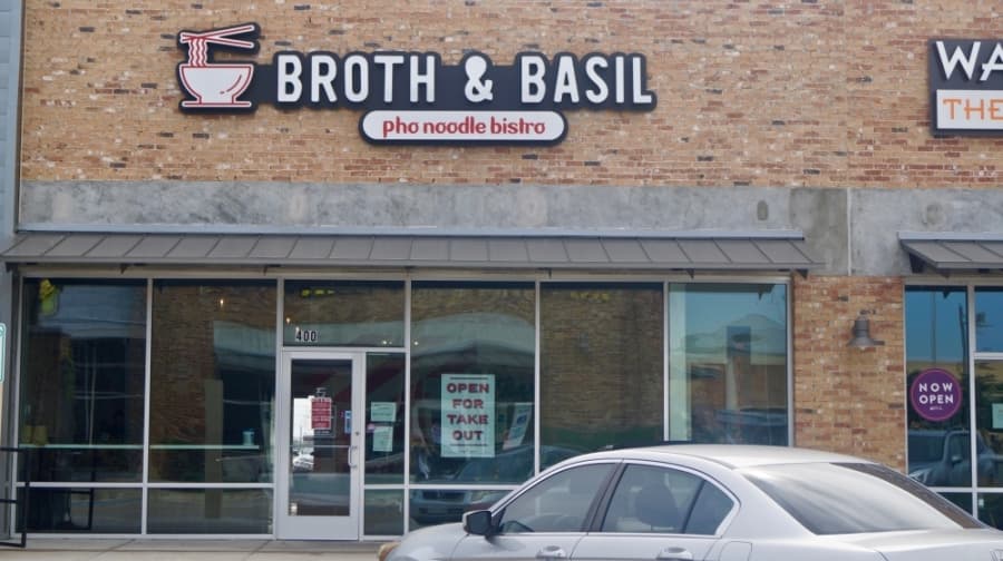 Broth & Basil, located in Stone Hill Town Center, advertises takeout services to customers. (Kelsey Thompson/Community Impact Newspaper)