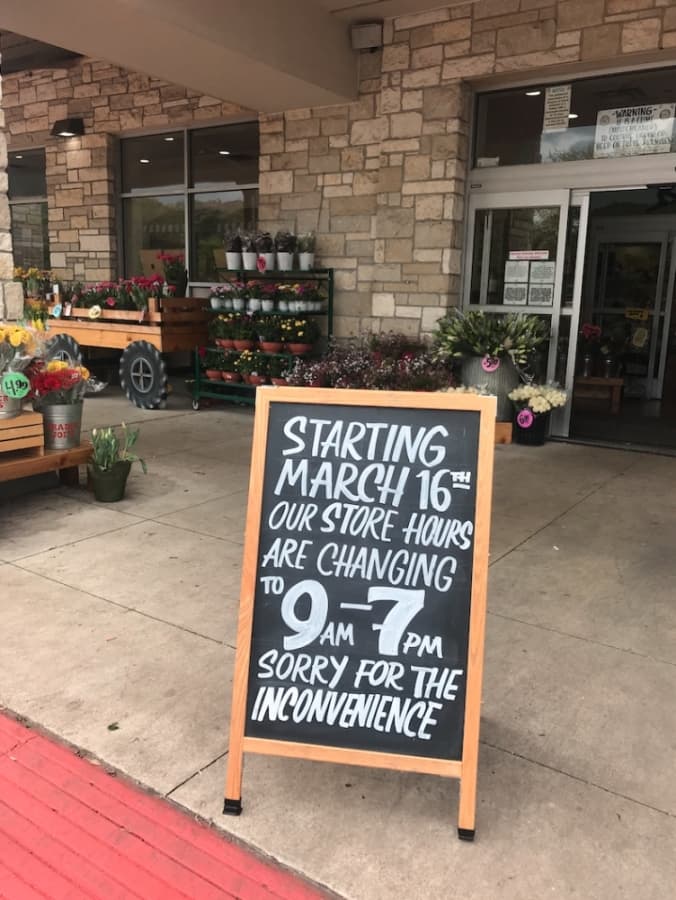 Rollingwood's Trader Joe's location displays a sign March 16 highlighting the store's adjusted hours. (Amy Rae Dadamo/Community Impact Newspaper)