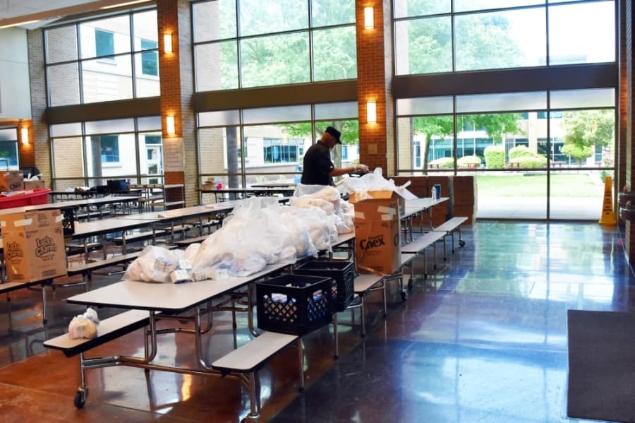  Staff at Audelia Creek Elementary School organize meals for pickup. (Makenzie Plusnick/Community Impact Newspaper)