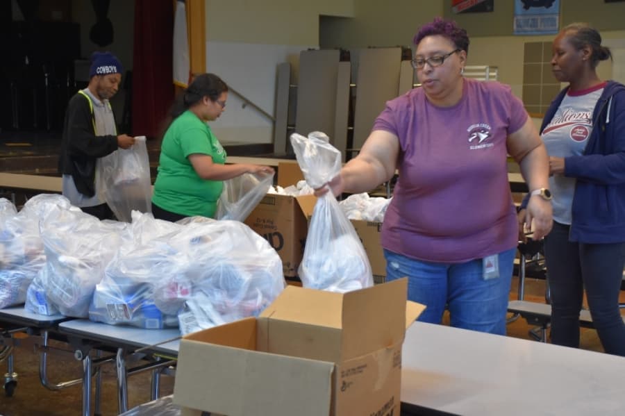 Audelia Creek Elementary cafeteria manager Janet Bealer helps assemble meals. (Makenzie Plusnick/Community Impact Newspaper)