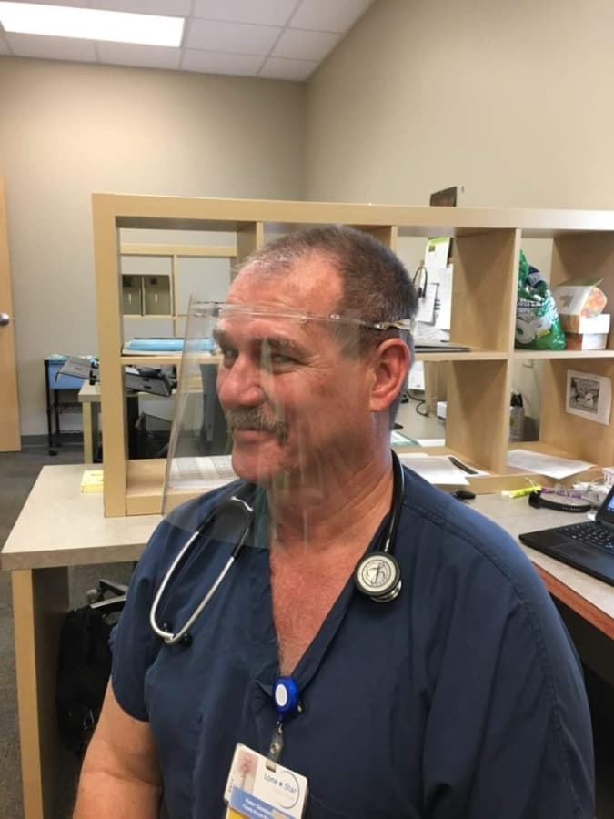 Nurse Practitioner Peter Gembol, who works at the Lone Star Circle of Care Georgetown Clinic, tests out the face shields. (Courtesy Georgetown Health Foundation)