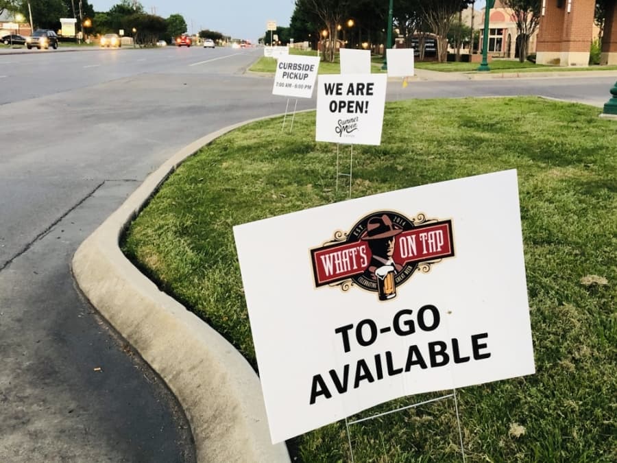 Multiple temporary yard signs advertise current options for restaurants at Keller Town Center. (Ian Pribanic/Community Impact Newspaper)