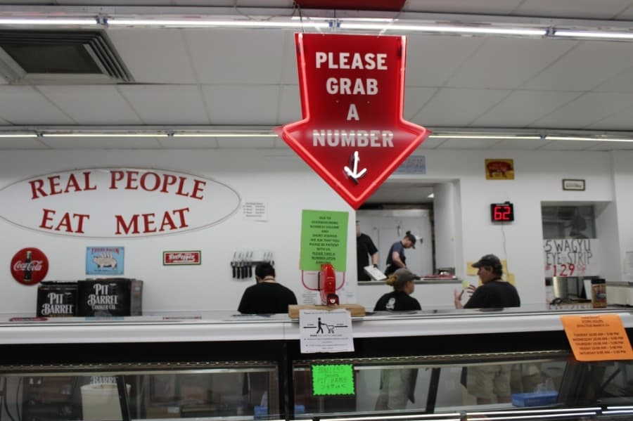 The staff at Hirsch's Meats in Plano operate the business on a busy Saturday in April. Employees have been given the option to stay home, leading the business to reduce store hours, owner Gary Hirsch said. (Daniel Houston/Community Impact Newspaper)
