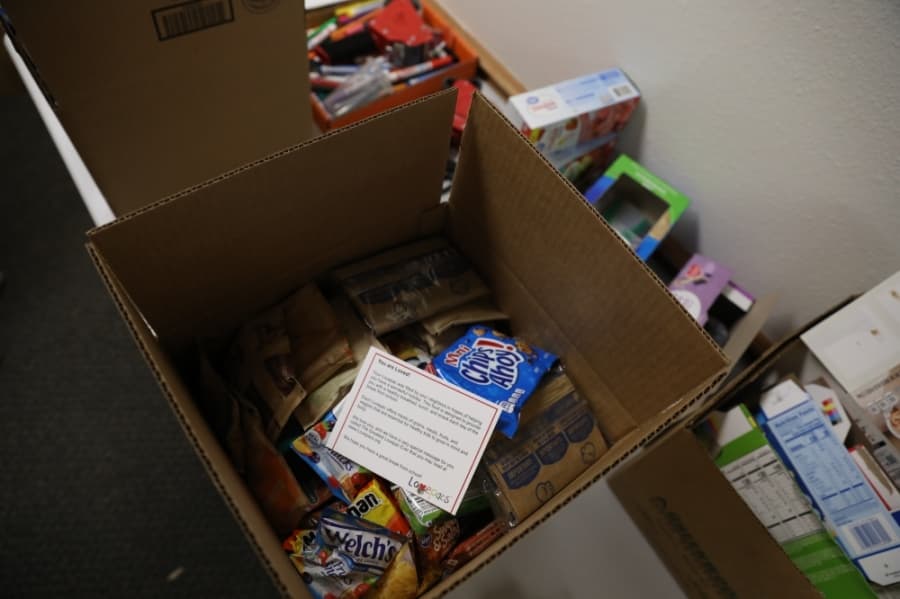 Each box from Lovepacs is filled with food for breakfast and lunch for a week as well as snacks and a note from the nonprofit that opens with "You are Loved." (Liesbeth Powers/Community Impact Newspaper)