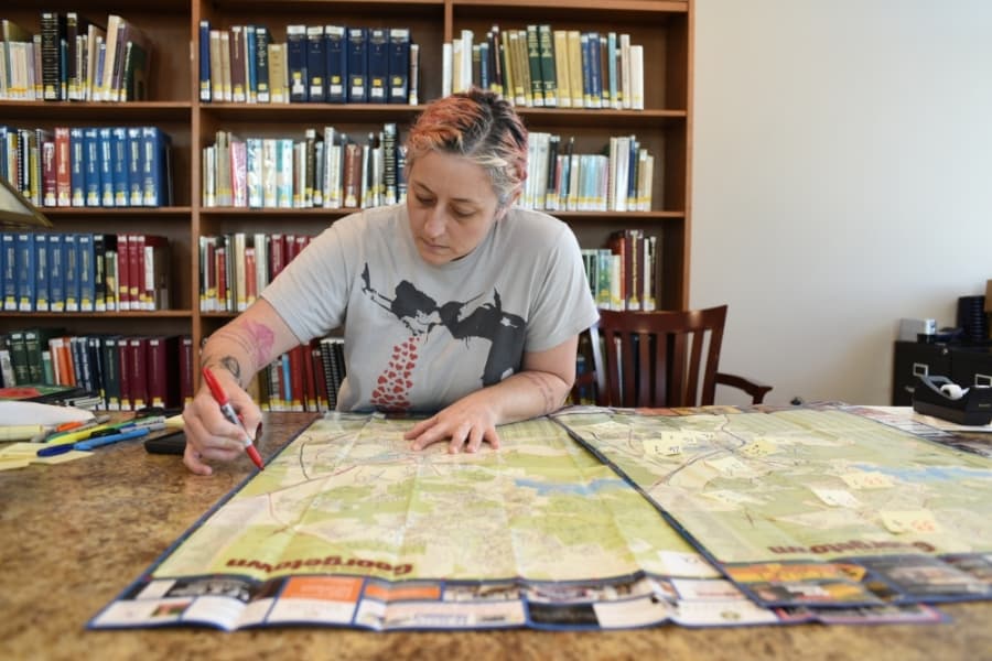 Georgetown Public Library staff member Kalena Powell  draws delivery zones on a city map April 7 as the organization prepared to launch its home delivery service. (Courtesy Joyce May)