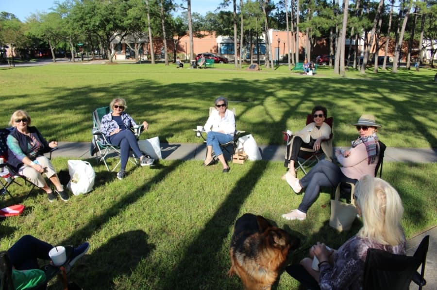Eight friends met in Kingwood Town Center Park April 15 to enjoy to-go appetizers from a nearby restaurant.(Kelly Schafler/Community Impact Newspaper)