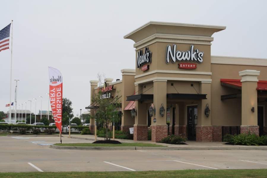 A banner at Newk's Eatry, located 20802 Katy Freeway, Katy, lets residents know the restaurant is ready for delivery and curbside ordering. The brand announced April 13 it would begin selling grocery items and meal kits, too.  (Jen Para/Community Impact Newspaper)