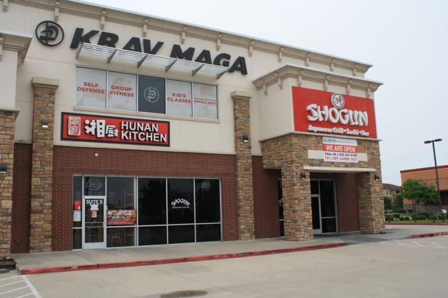 Hunan Kitchen and Shogun created handmade and printed signs, respectively, to communicate to customers their to-go, delivery and discount options. However, Cowboy Chicken, which is located in the same strip center, was temporarily closed during the coronavirus as of April 4. (Jen Para/Community Impact Newspaper)