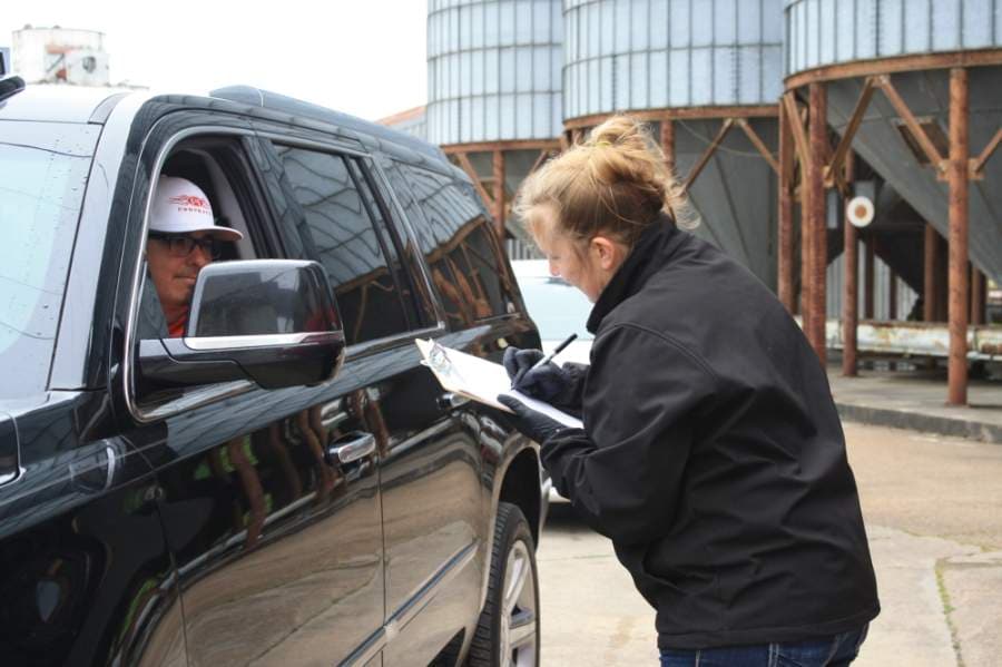 MKT Distillery co-owner Nici Jessett takes an order from a drive-thru customer. The distillery, located at 5373 First St., is also giving away free sanitizer to residents, local organizations, first responders and businesses in need. (Jen Para/Community Impact Newspaper)