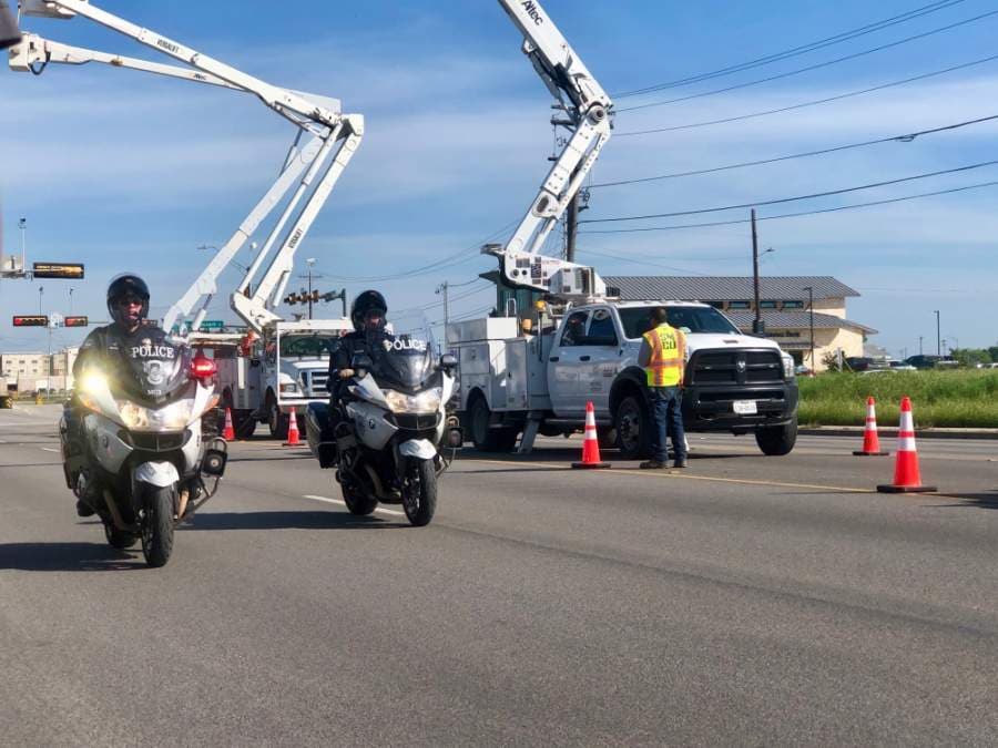 The San Marcos Fire Department and San Marcos Utility had bucket trucks along the procession route at Yarrington and along Wonder World on the west side of the overpass in honor of Putnam. (Evelin Garcia/ Community Impact Newspaper)