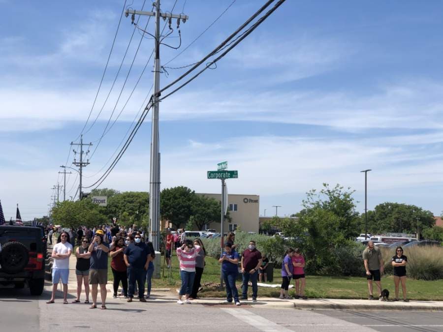 San Marcos residents gathered at Wonder World Drive to pay their respects to fallen officer Justin Putnam, who was killed in the line of duty April 18 18. (Evelin Garcia/ Community Impact Newspaper)