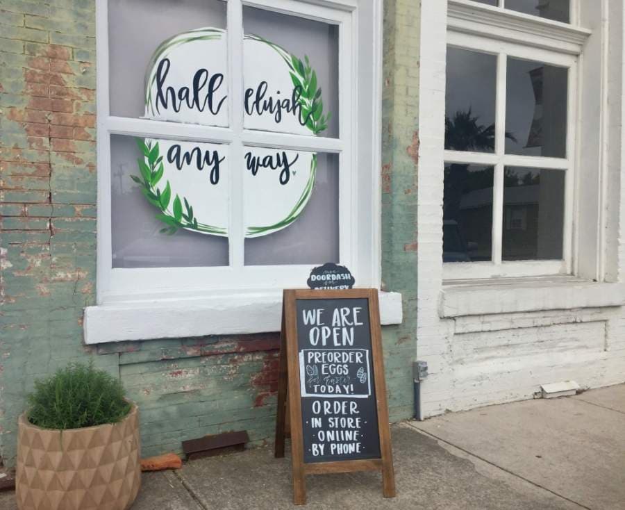 Downtown businesses have placed signage on windows, doors and easels to let customers know their current operating procedures during the pandemic. (Taylor Jackson Buchanan/Community Impact Newspaper)