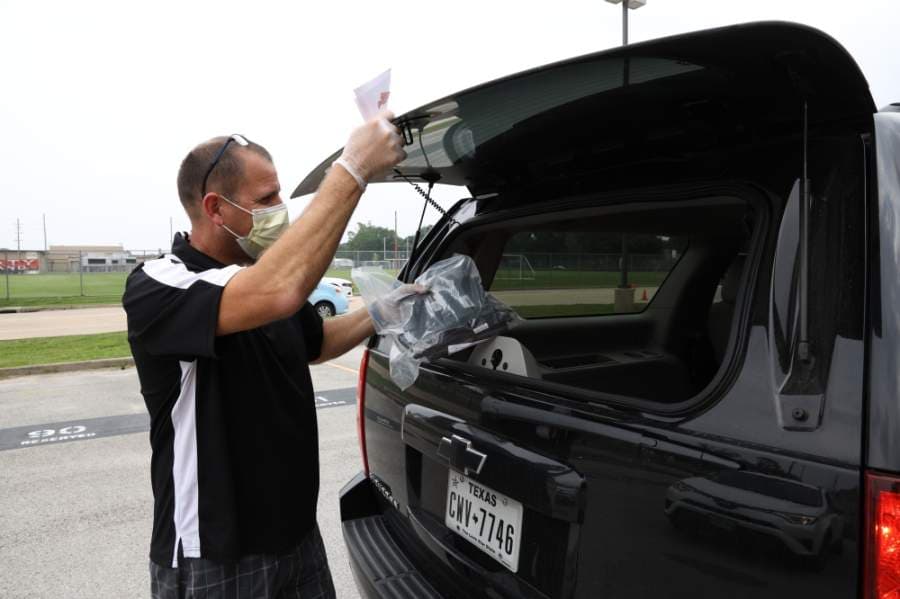 Katy ISD staff members distribute technology devices for students on April 22. (Courtesy Katy ISD)