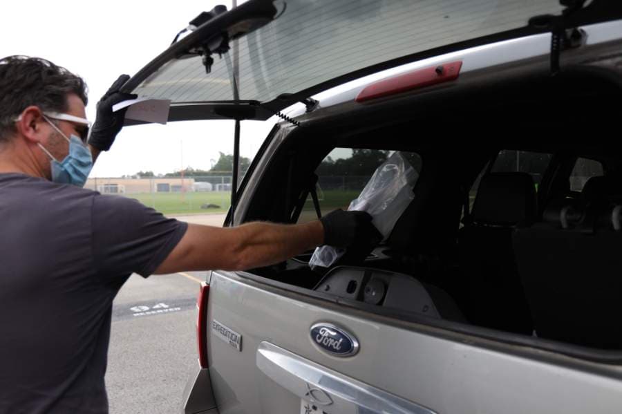 Katy ISD staff members distribute technology devices for students on April 22. (Courtesy Katy ISD)