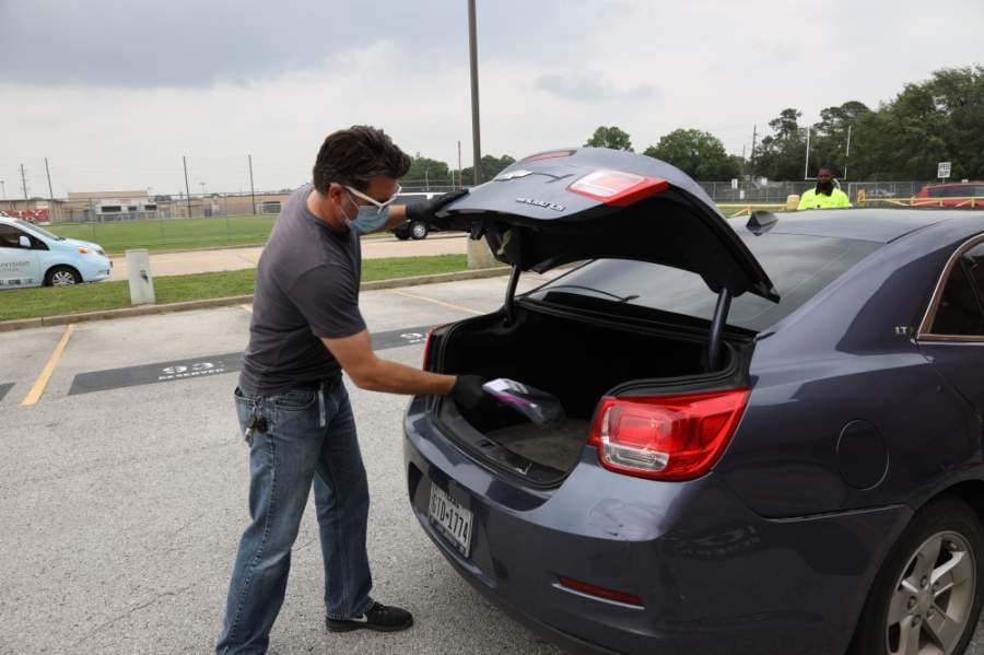Katy ISD staff members distribute technology devices for students on April 22. (Courtesy Katy ISD)