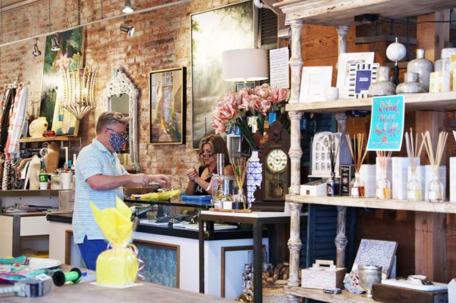 Michael Hamilton places the finishing touches on an order before carrying it out to the car. He cleared a space at the front of La Foofaraw specifically for wrapping orders, he said. (Liesbeth Powers/Community Impact Newspaper)