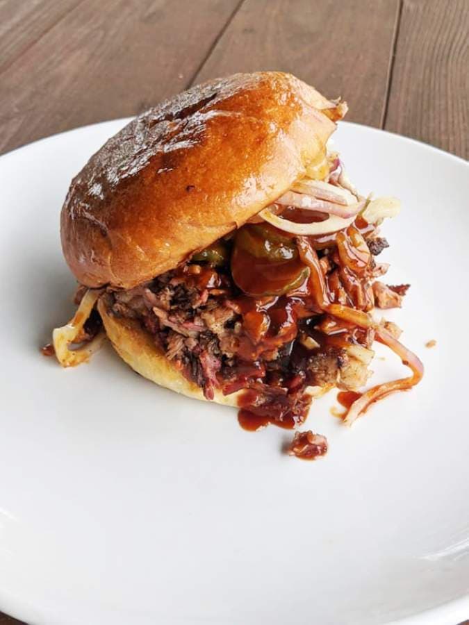 The Chopped BBQ Sandwich ($12) features brisket, barbecue sauce, pickles, red onion and cheddar cheese on a housemade bun. (Courtesy Tressie's Southern Kitchen)