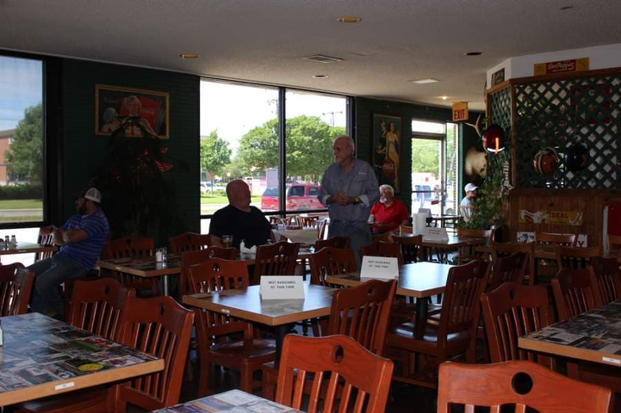 Bill Smith talks to diners in his restaurant, Bill Smith's Cafe, after reopening May 1. (Miranda Jaimes/Community Impact Newspaper)