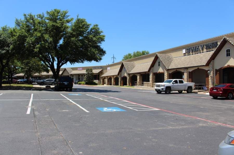 The normally packed parking lot at II Creeks Plaza was mostly empty Friday afternoon. (Olivia Lueckemeyer/Community Impact Newspaper)