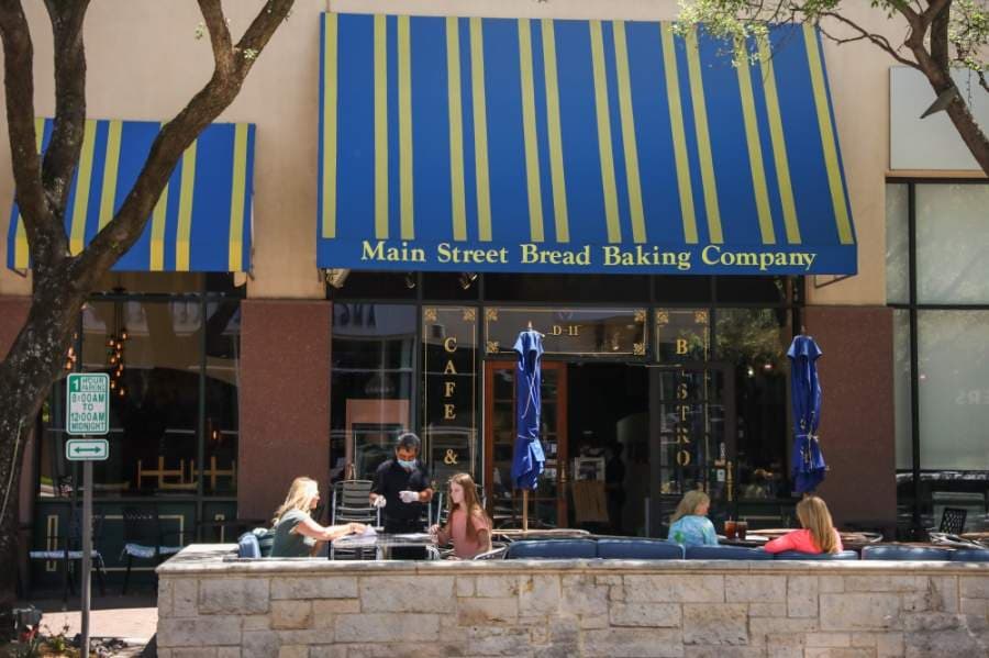 A number of residents could be seen dining at the Main Street Bread Baking Co. at the Shops at Legacy this afternoon. Bailey Hollingsworth, not pictured, said she chose to dine there with her friend because she missed the social interaction and the feel of a restaurant. Hollingsworth and her friend planned to walk around the area to see what was open after eating, she said. (Liesbeth Powers/Community Impact Newspaper)