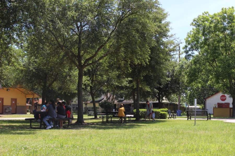 Community members gather at the Tomball Historic Depot Plaza on May 1. (Anna Lotz/Community Impact Newspaper)