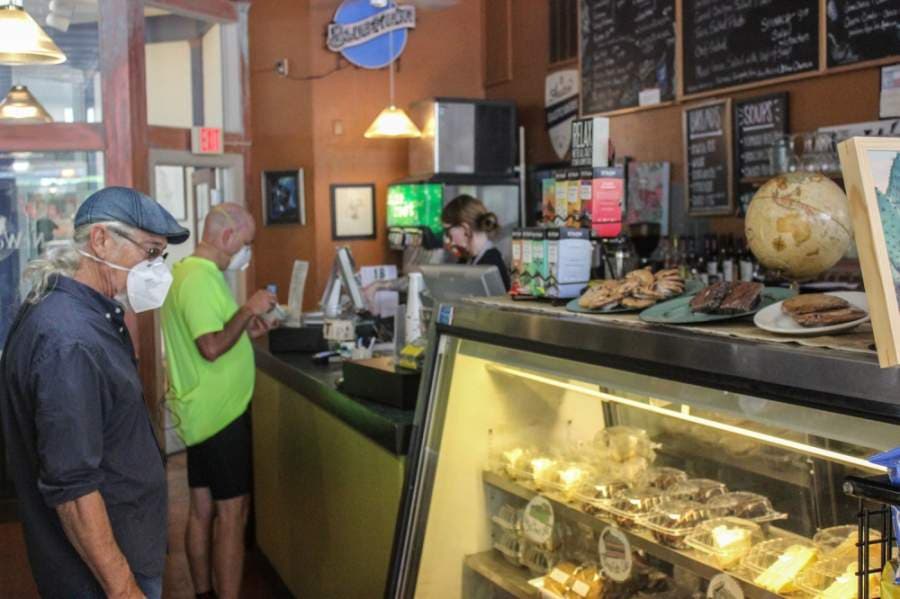 Customers wait in line at NeWorlDeli on May 1. (Christopher Neely/Community Impact Newspaper)