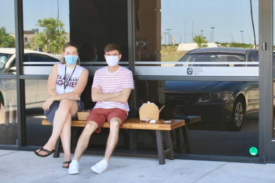 On May 3, two hungry customers ate on a bench outside BingSu and Chung Chun, located inside Katy Asian Town at 23119 Colonial Parkway, Ste. B16, Katy. (Jen Para/Community Impact Newspaper)