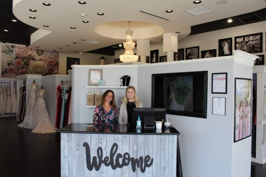 Owner Kellie Simmons, right, and staff member Jenna Roth are limiting walk-ins and encourage smaller groups at Sophia's Gowns, 1000 S. Main St., Ste. 505, Keller. (Ian Pribanic/Community Impact Newspaper)
