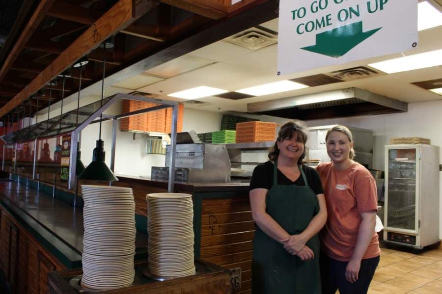 Following a recommendation from corporate, Double Dave's Pizzaworks franchisee Andrea Alexandrides, left, does not plan on opening the store's dining room at 800 S. Main St., Keller before mid-May. (Ian Pribanic/Community Impact Newspaper)