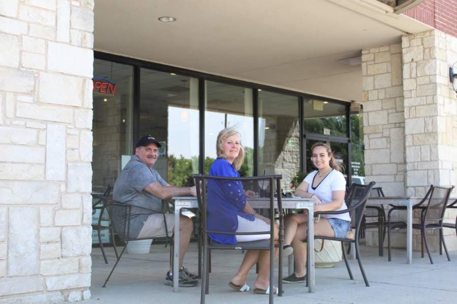 The Defranco Family, made up of Kent, Cindy and Brittney, enjoy an afternoon meal at DeVivo Bros. Eatery in Keller on May 1, the first day of reduced restrictions related to the COVID-19 pandemic. (Ian Pribanic/Community Impact Newspaper)