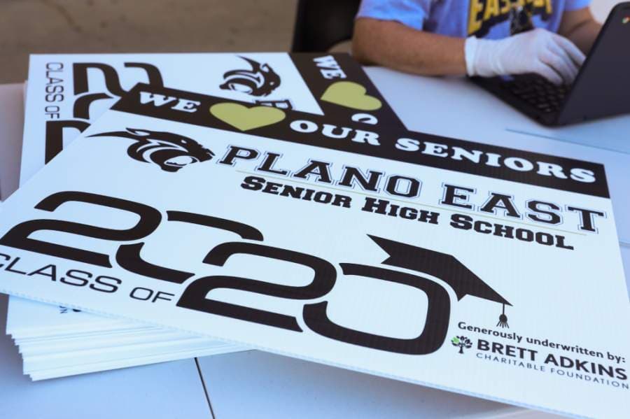 Each senior in line at Plano East Senior High School received a senior yard sign to display in their front yards. Each campus has its own colors for the sign. (Liesbeth Powers/Community Impact Newspaper)