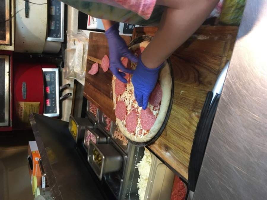 An eight11 Place staff member makes a pizza. (Courtesy eight11 Place)