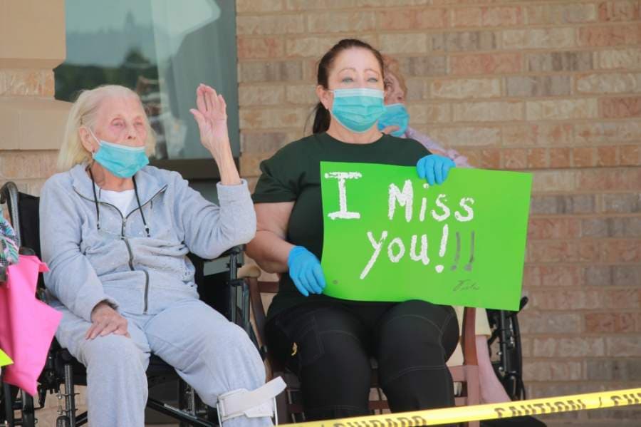 Organized by the Montgomery Area Chamber of Commerce, Montgomery residents drove in front of Live Oak Senior Care May 7 to lift the spirits of its residents and staff. (Andy Li/Community Impact Newspaper)