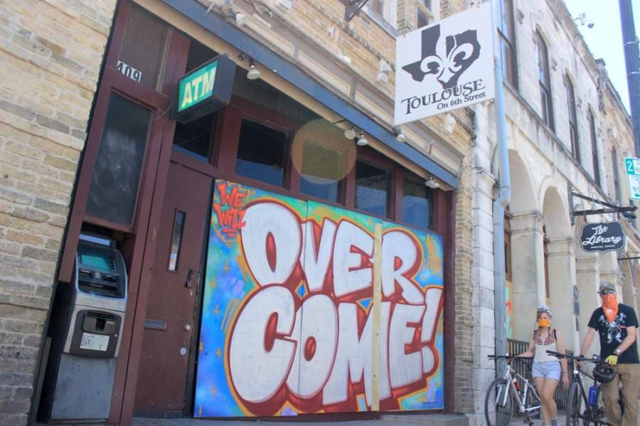Many bars on Sixth Street remain boarded up, and some were painted by artists from the HOPE Outdoor Gallery. On May 18, Gov. Greg Abbott announced that bars could reopen on May 22. (Jack Flagler/Community Impact Newspaper)