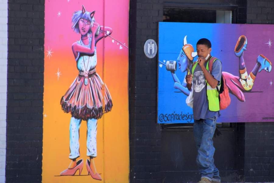 Many bars on Sixth Street remain boarded up, and some were painted by artists from the HOPE Outdoor Gallery. On May 18, Gov. Greg Abbott announced that bars could reopen on May 22. (Jack Flagler/Community Impact Newspaper)