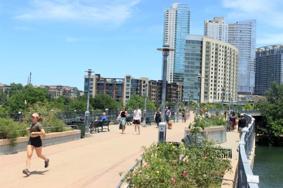 Austinites walk, run and bike on the Pfluger Bridge on a warm late spring afternoon. (Jack Flagler/Community Impact Newspaper)